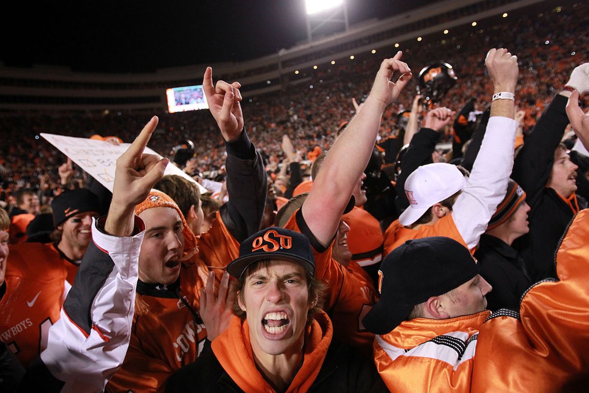 STILLWATER, OK - DECEMBER 03:  Oklahoma State Cowboys fans celebrate on the field after a 44-10 win against the Oklahoma Sooners at Boone Pickens Stadium on December 3, 2011 in Stillwater, Oklahoma.  (Photo by Ronald Martinez/Getty Images)