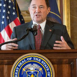 Utah Gov. Gary Herbert makes an opening statement prior to signing HB127, which adds the "In God We Trust" license plate to the standard options available, at the Capitol in Salt Lake City on Monday, March 21, 2016.
