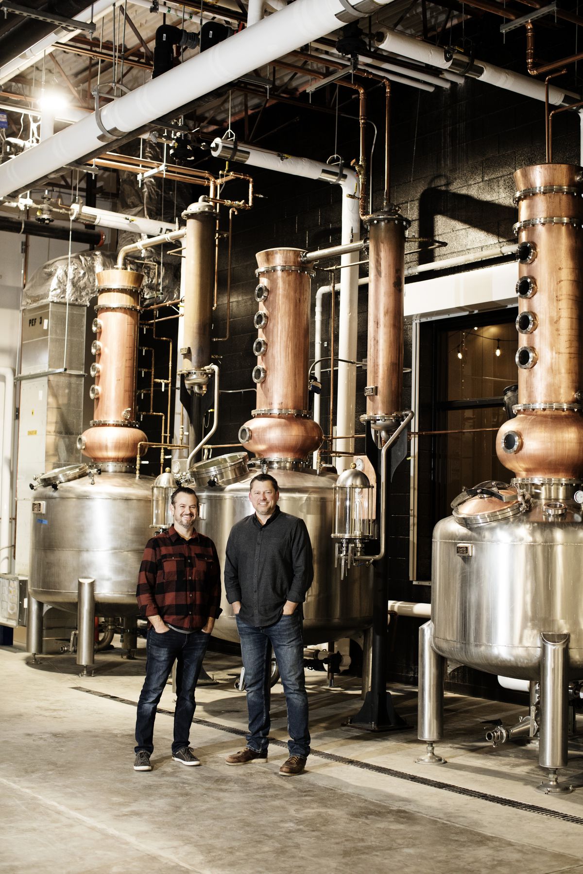 A photo of Tattersall Distilling’s founders at their shiny new distillery.