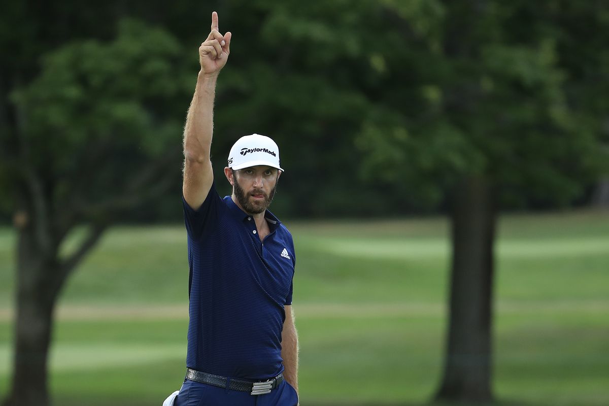 Dustin Johnson of the United States celebrates making his putt for birdie on the 18th hole to force a playoff during the final round of the BMW Championship on the North Course at Olympia Fields Country Club on August 30, 2020 in Olympia Fields, Illinois.