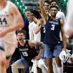 San Diego Toreros forward Alex Floresca (15) and San Diego Toreros guard Olin Carter III (3) join with their teammates in cheering after a basket as the BYU Cougars and San Diego Toreros play in WCC tournament action at the Orleans Arena in Las Vegas on Saturday, March 9, 2019. San Diego won 80-57.