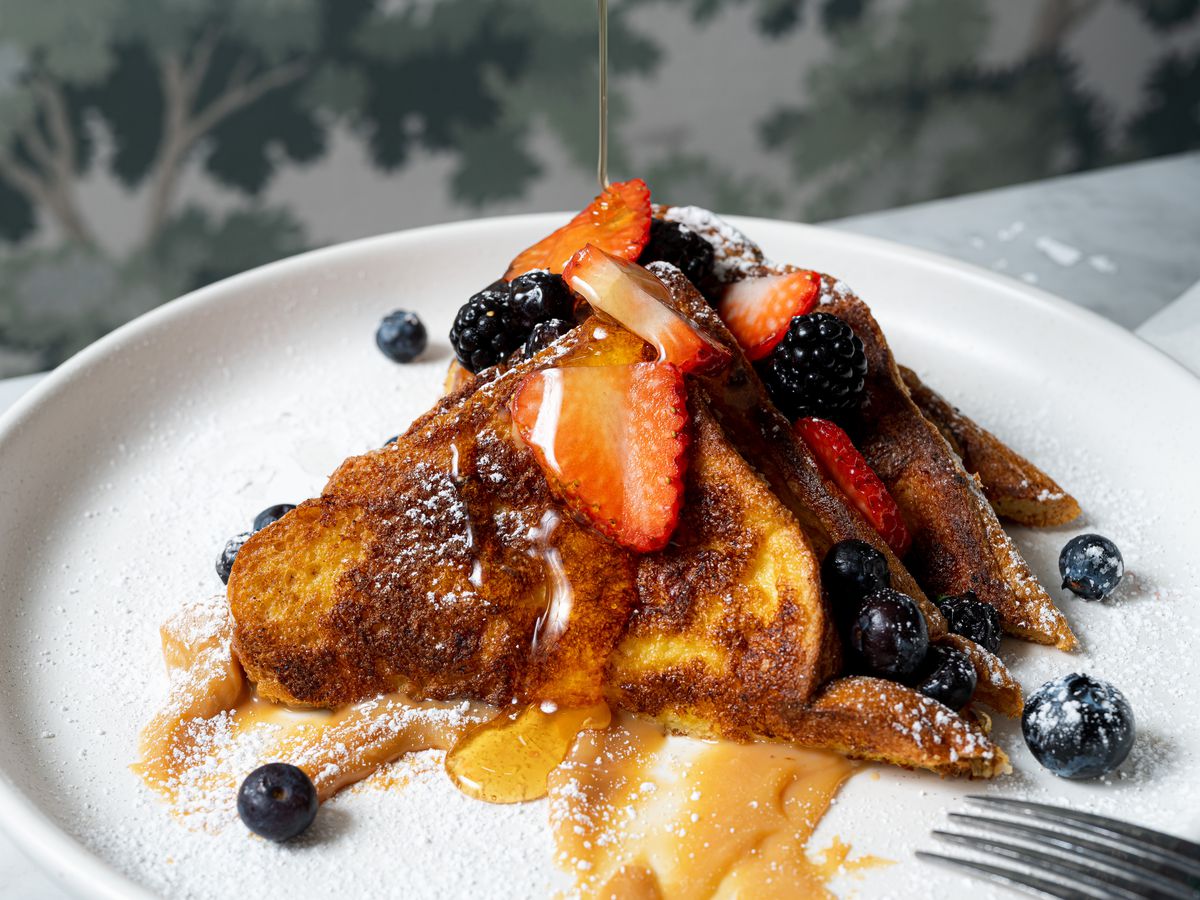 Slices of French toast topped with berries and maple syrup at Eloise Nichols.