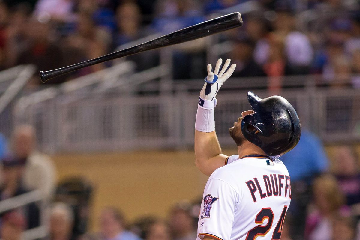 Trevor Plouffe stands atop a map of the United States. Wherever his bat lands, he signs.