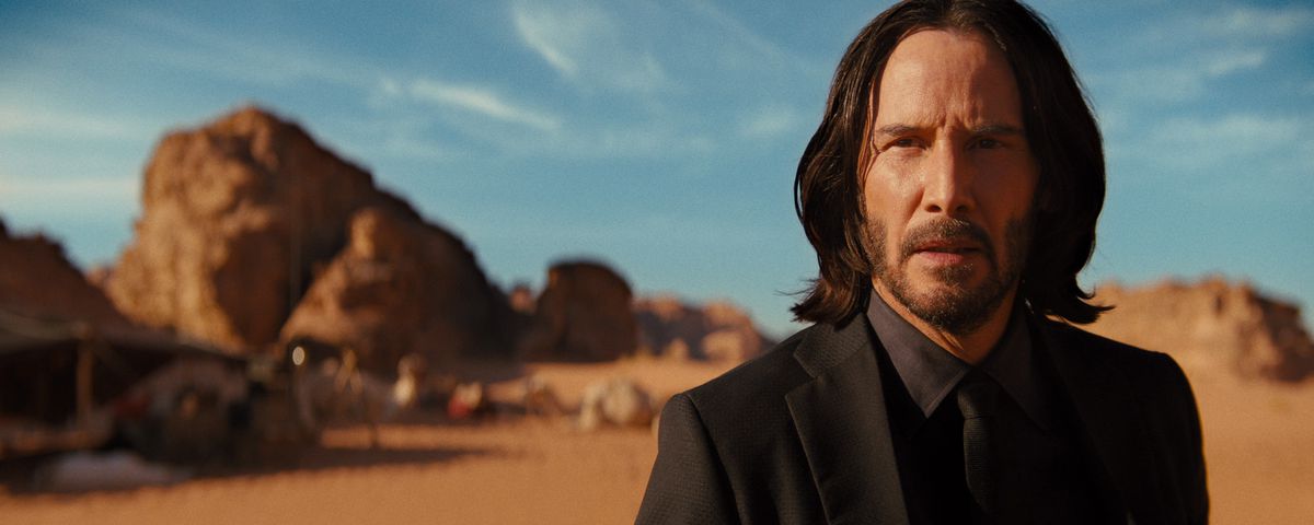 John Wick (Keanu Reeves) stands in a desert in Jordan in John Wick: Chapter 4
