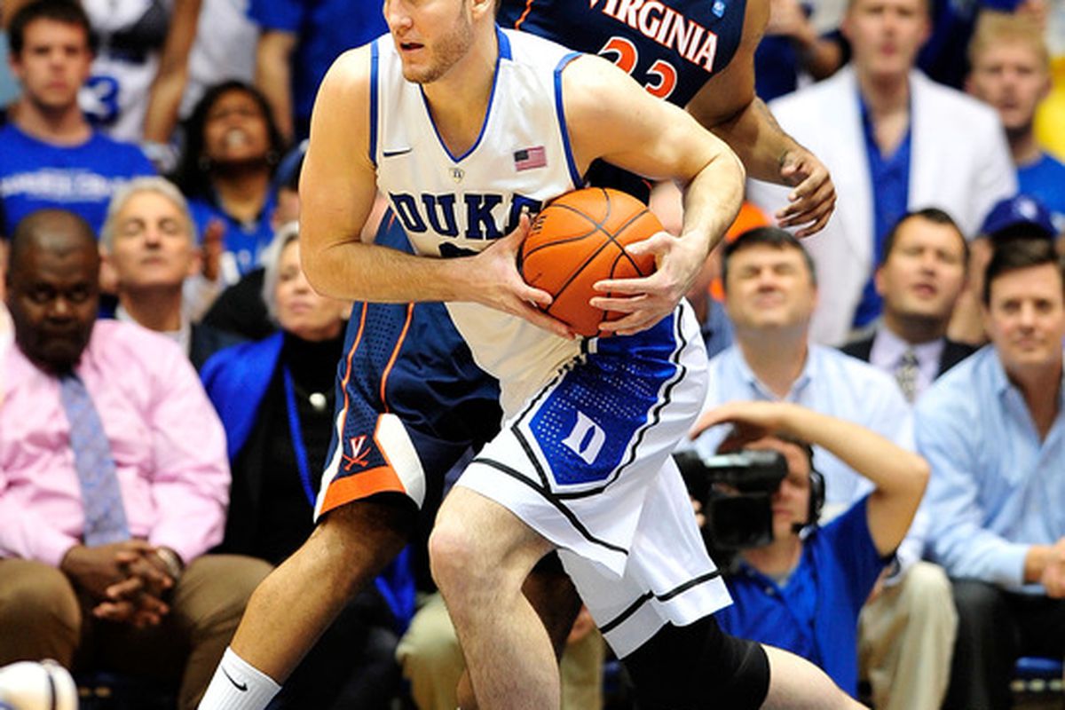 DURHAM, NC - JANUARY 12:  Miles Plumlee #21 of the Duke Blue Devils takes a rebound away from Mike Scott #23 of the Virginia Cavaliers  (Photo by Grant Halverson/Getty Images)