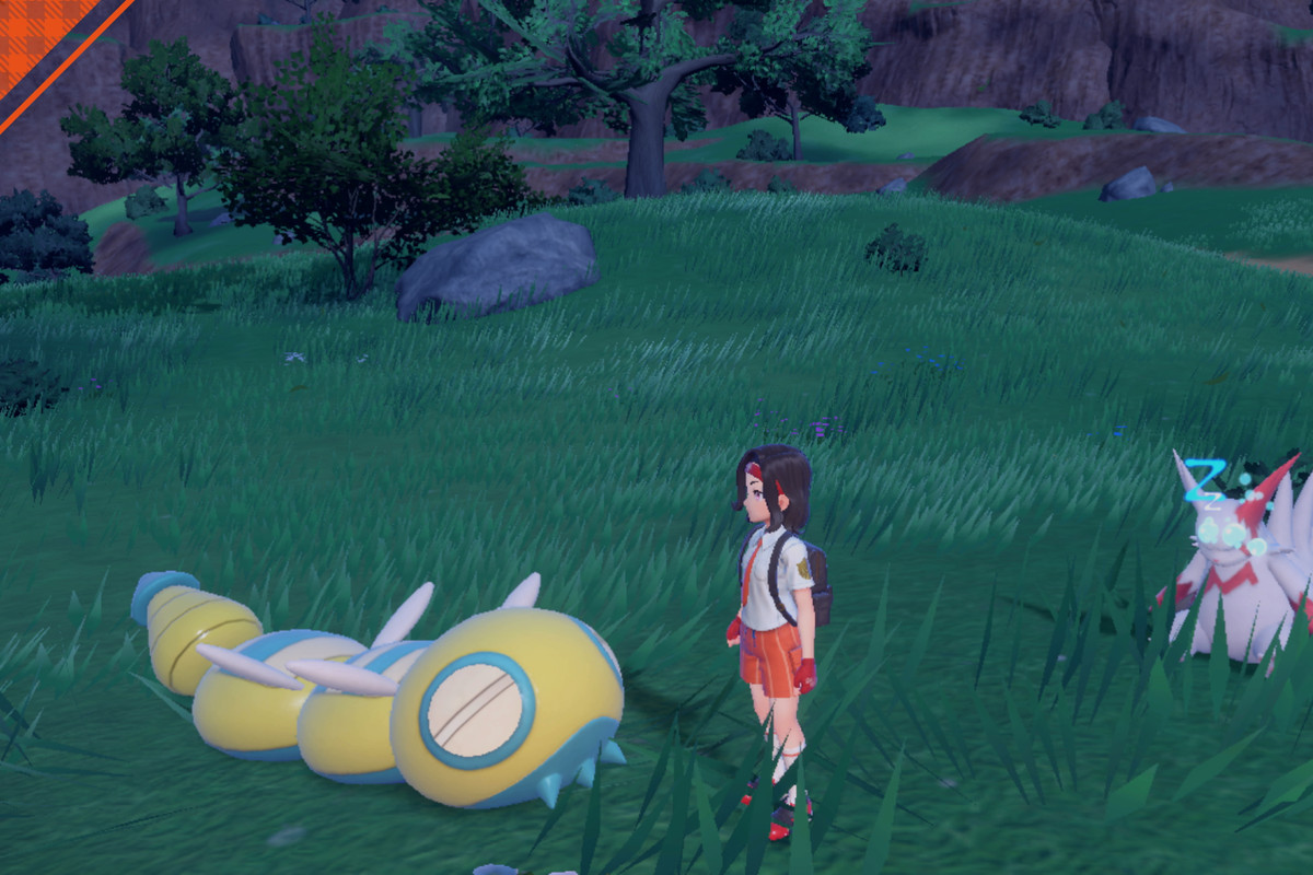 An image of a trainer in Pokémon Scarlet and Violet having a picnic and standing next to a Dudunsparce. This Dudunsparce has two middle segments; with four segments in total.