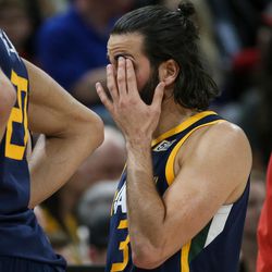 Utah Jazz guard Ricky Rubio (3) holds his eye after being fouled by Atlanta Hawks guard Dennis Schroeder (17) at Vivint Smart Home Arena in Salt Lake City on Tuesday, March 20, 2018.