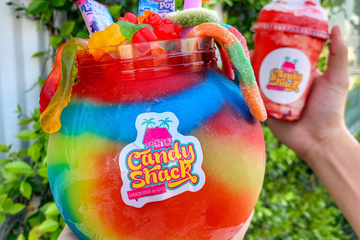A fishbowl of frozen daiquiri garnished with candy 