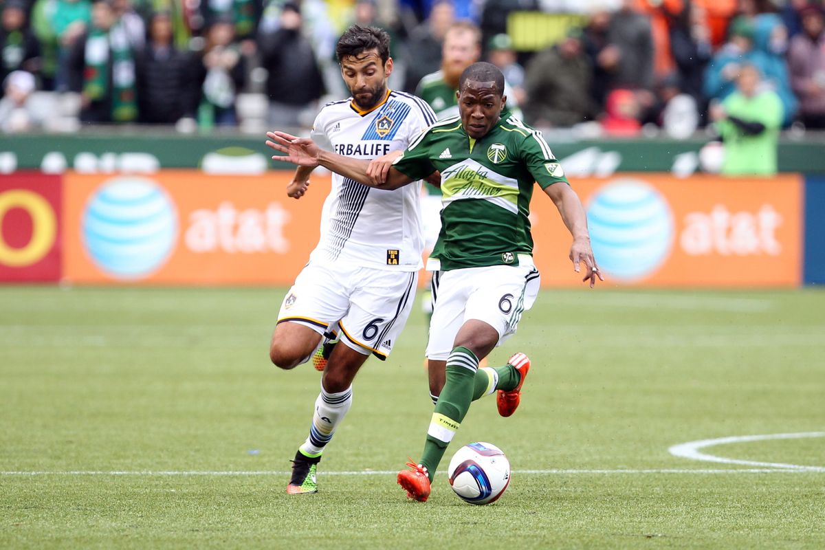 Darlington Nagbe fends off a Galaxy defender while dribbling during the Portland-L.A. game on Sunday.