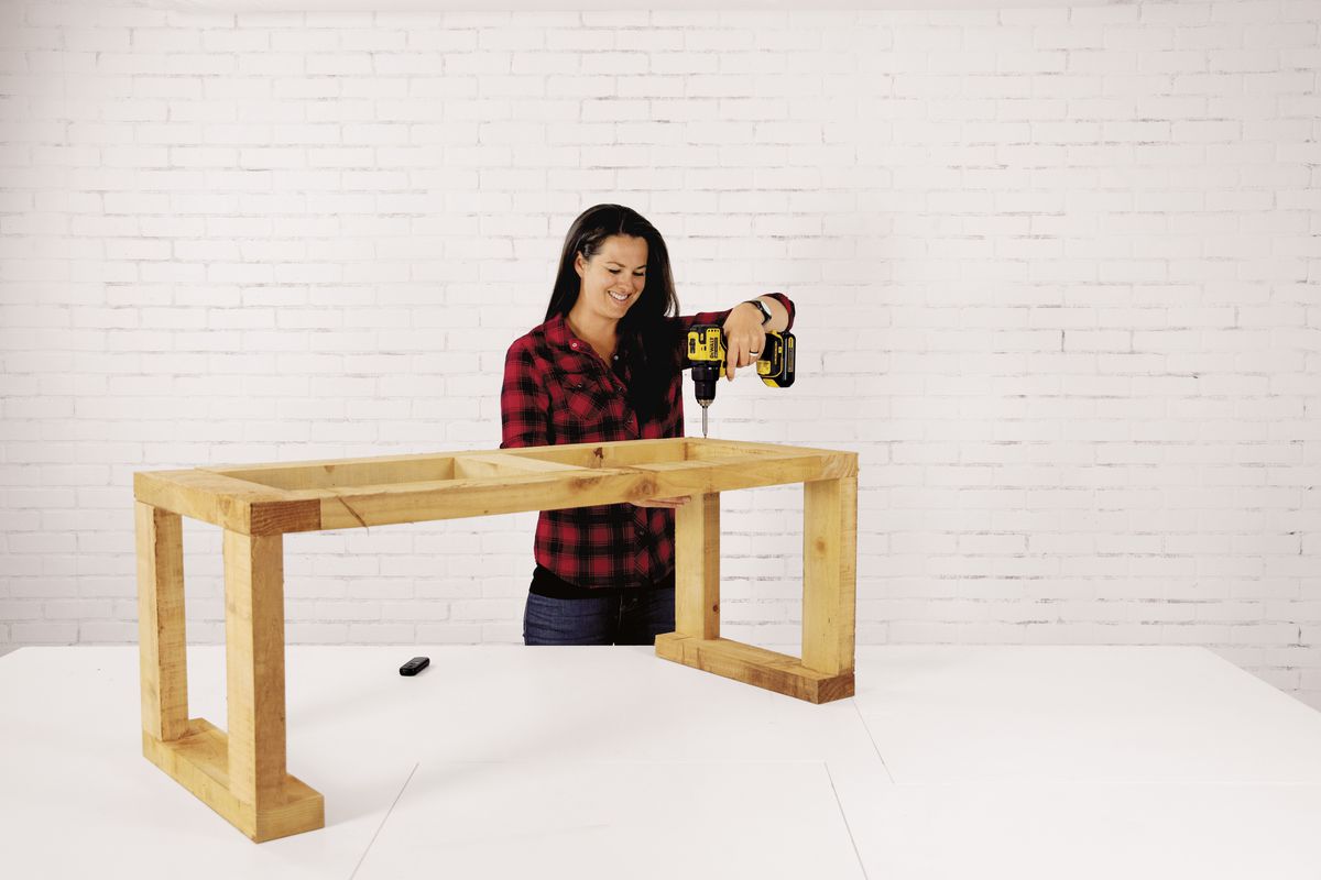 Attach the top and legs to the firewood storage bench.