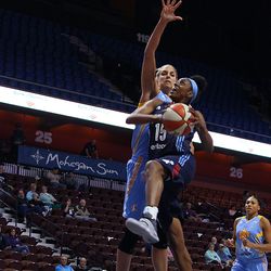 Atlanta Dream's Tiffany Hayes (15) drives to the basket against Chicago Sky's Elena Delle Donne (11).