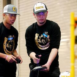 Aye Chan and Abdul Ayubi and other students from Cottonwood High School get in some practice as they work to compete in the First Robotics Competition Utah Regional event at the Maverik Center in West Valley City, Utah, on Friday, March 29, 2019.