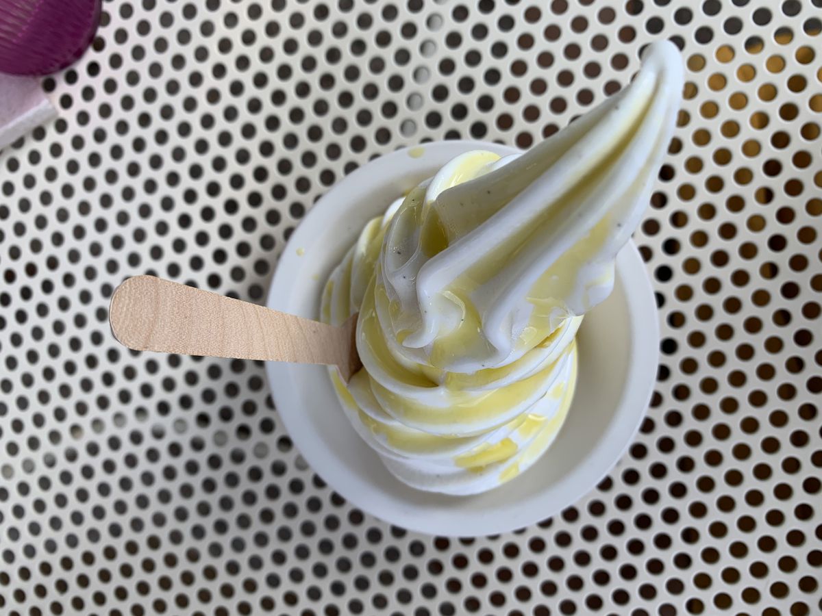 A cup of soft serve with olive oil from the top.