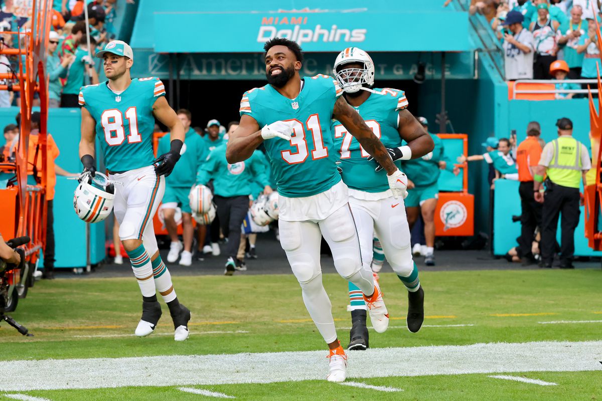 Raheem Mostert #31 of the Miami Dolphins takes the field during player introductions prior to the game against the Dallas Cowboys at Hard Rock Stadium on December 24, 2023 in Miami Gardens, Florida.