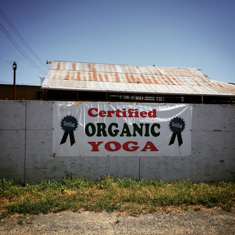 Organic yoga sign on slaughterhouse fence