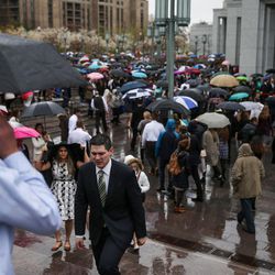 Conferencegoers stand in line in the rain as they arrive for the  afternoon session of the LDS Church’s 187th Annual General Conference at the Conference Center in Salt Lake City on Sunday, April 2, 2017.