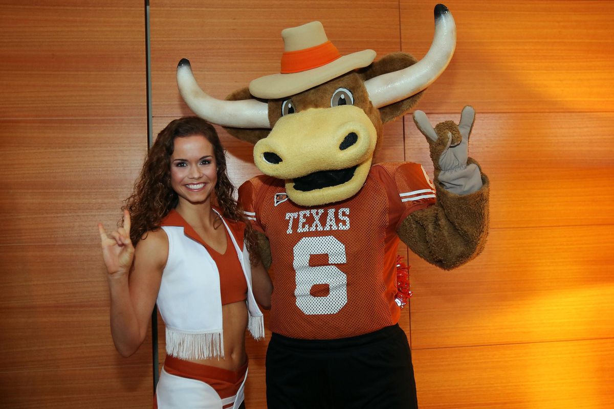 Jul 24, 2012; Dallas, TX, USA; A Texas Longhorns cheerleader poses for a photo with mascot Hook Em during Big 12 Media Day at the Westin Galleria.  Mandatory Credit: Kevin Jairaj-US PRESSWIRE