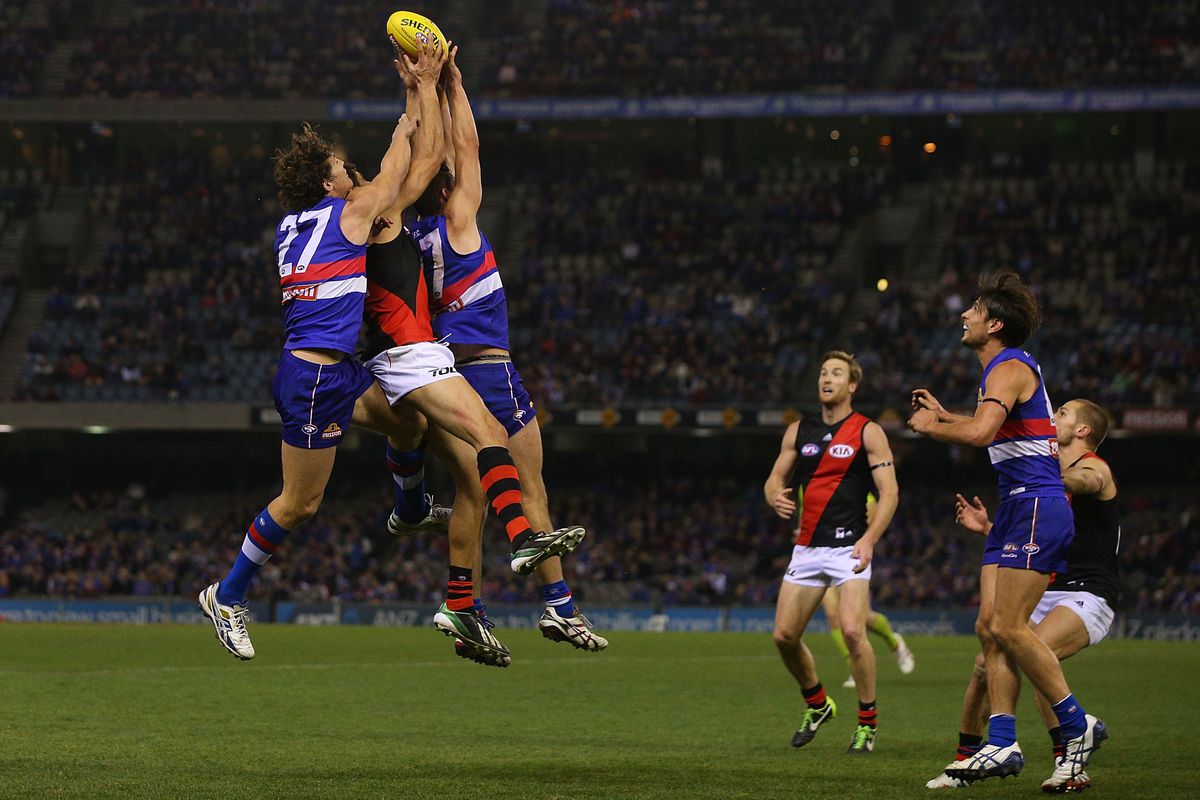 Patrick Ryder of the Bombers marks the ball against Will Minson of the Bulldogs (L) during the round 18 AFL match between the Western Bulldogs and the Essendon Bombers at Etihad Stadium on July 20, 2014 in Melbourne, Australia.