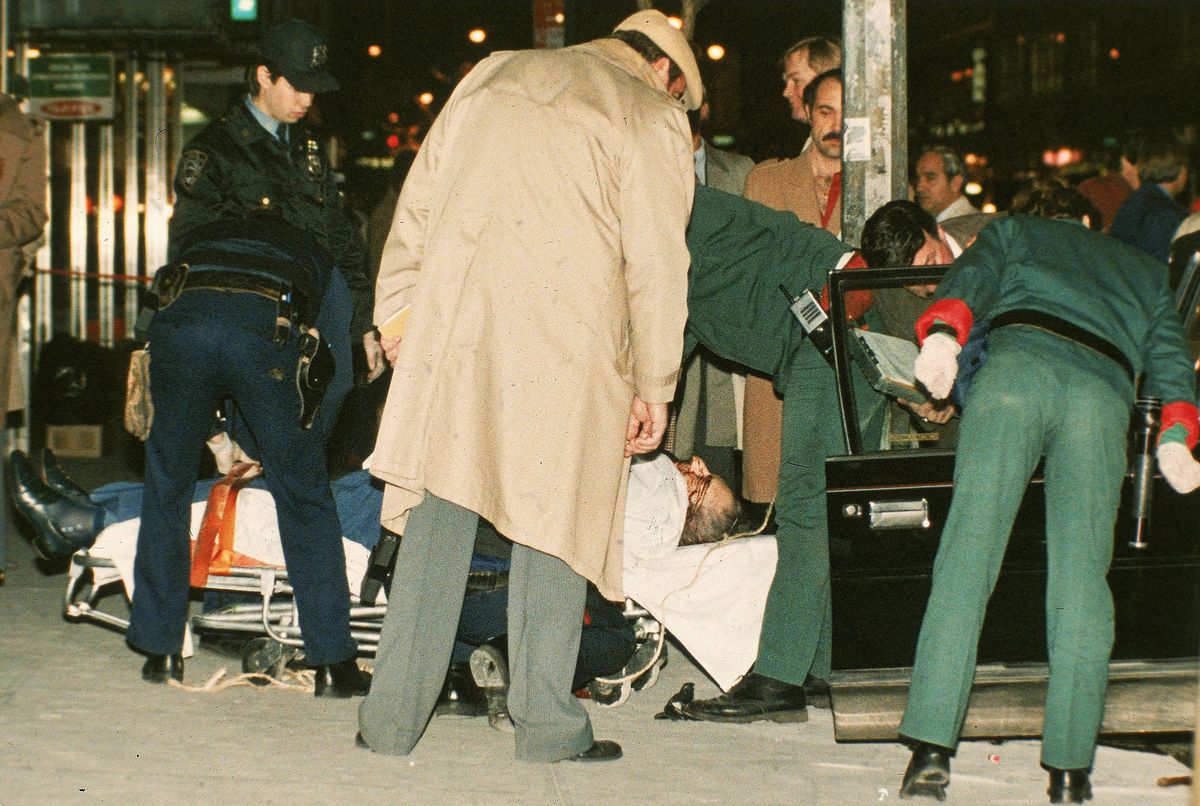 In this Dec. 16, 1985 file photo, the body of mafia crime boss Paul Castellano lies on a stretcher outside the Sparks Steak House in New York after he and his bodyguards were gunned down at the direction of John Gotti, who then took over as boss. | AP fil