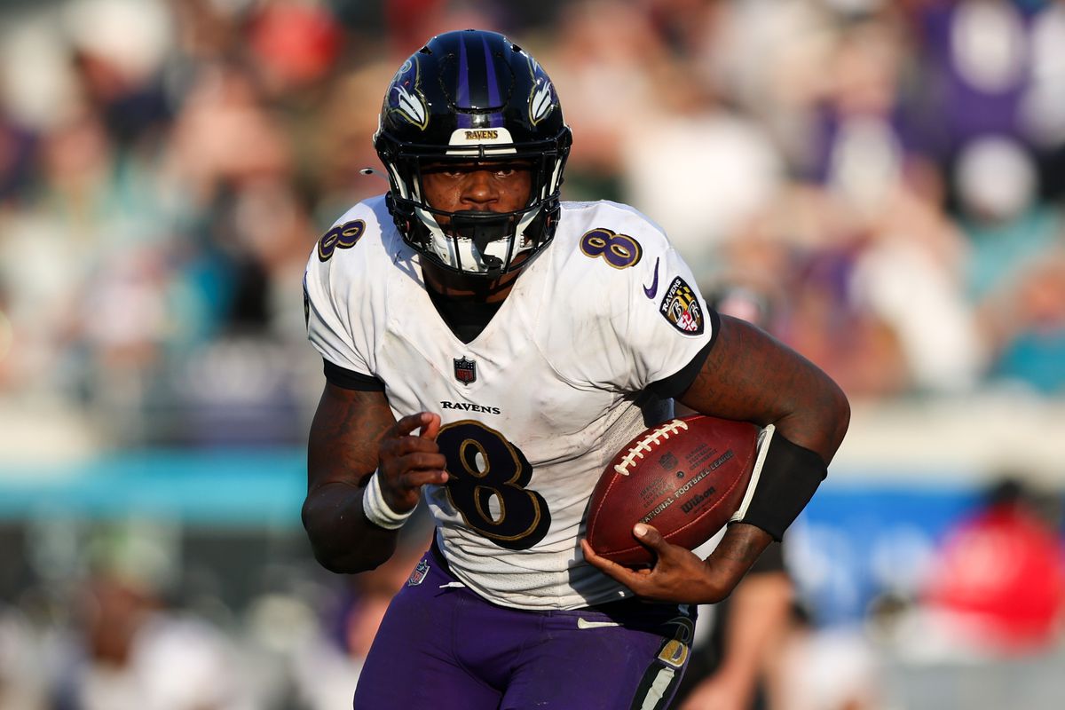 Baltimore Ravens quarterback Lamar Jackson (8) runs with the ball against the Jacksonville Jaguars in the fourth quarter at TIAA Bank Field.
