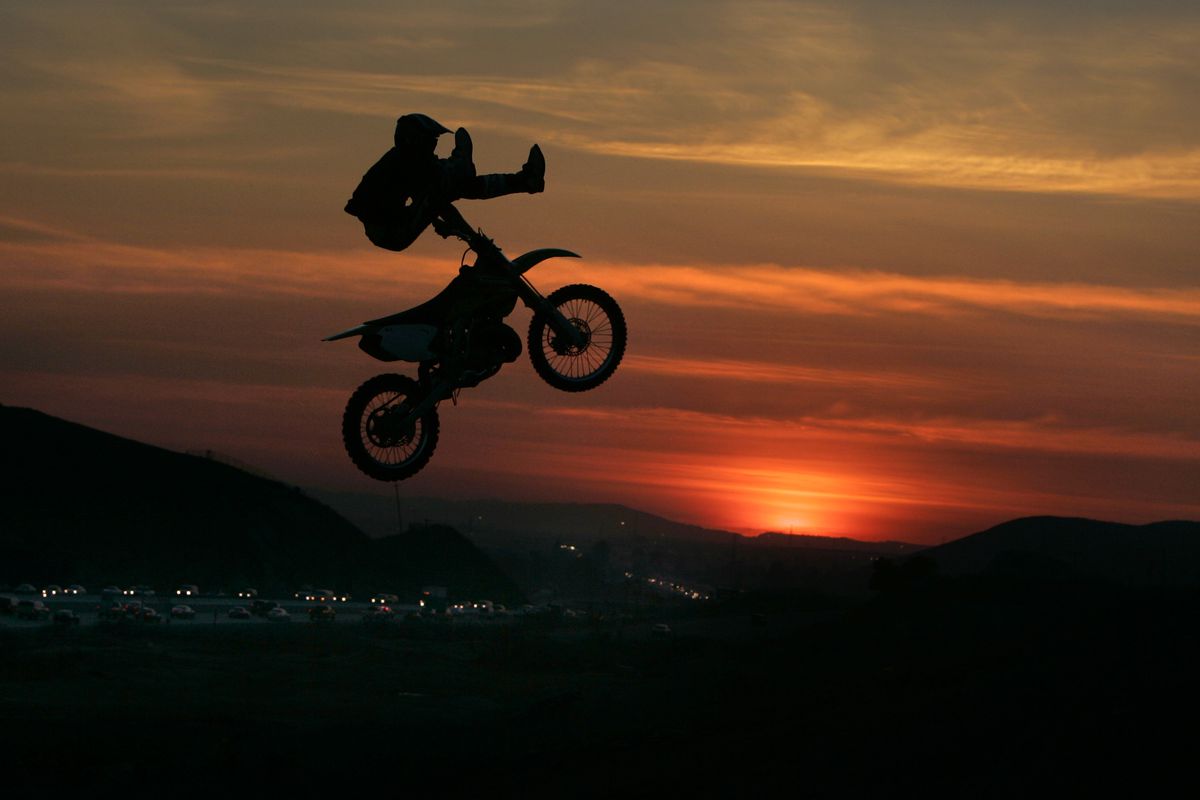 Dirt bike rider Alex Goutier, 20, of Rancho Cucamonga, jumps his Kawasaki KX 250 over a jump at sun