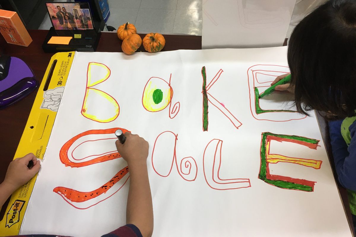 Children help color a bake sale sign for a PTA fundraiser at New York City's P.S. 165.