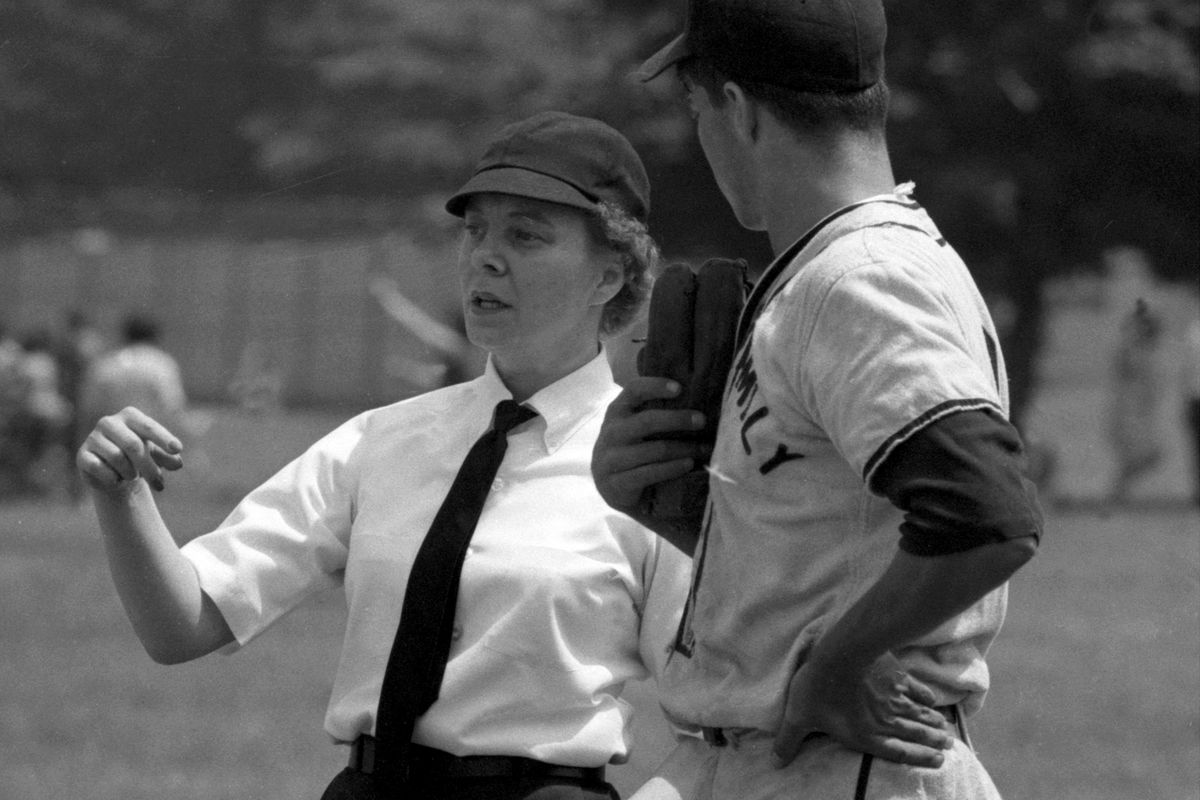 Woman umpire Bernice Gera at Holy Family baseball game at Cu