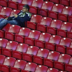 A Seattle Seahawks fan sits in the stands after  the second half of NFL Super Bowl XLIX football game against the New England Patriots Sunday, Feb. 1, 2015, in Glendale, Ariz. The New England Patriots won 28-24. (AP Photo/Ross D. Franklin) 