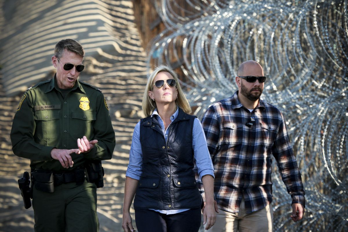 Kirstjen M. Nielsen, Secretary of the Department of Homeland Security, tours the border area with San Diego Section Border Patrol Chief Rodney Scott (L) at Borderfield State Park along the United States-Mexico Border fence in San Ysidro, California on Nov