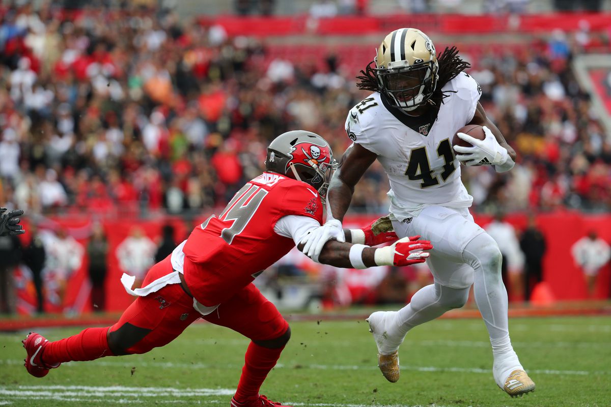 New Orleans Saints running back Alvin Kamara runs the ball against Tampa Bay Buccaneers safety Mike Edwards during the first quarter at Raymond James Stadium.