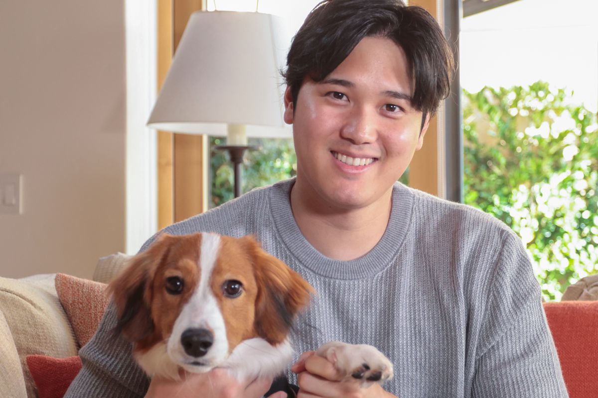 Shohei Ohtani holding his dog. 