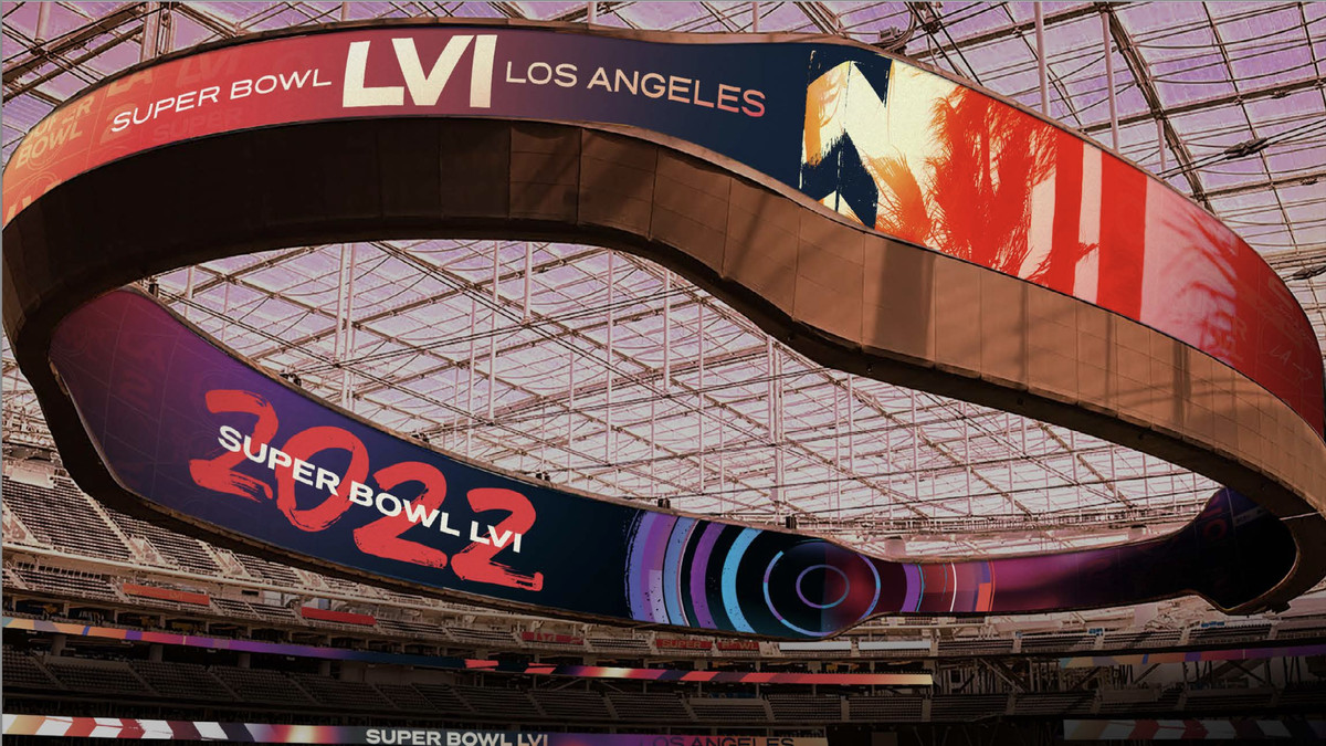 A large display screen engulfs the interior of SoFi Stadium in a large ring, with signs that read “Super Bowl LVI.”
