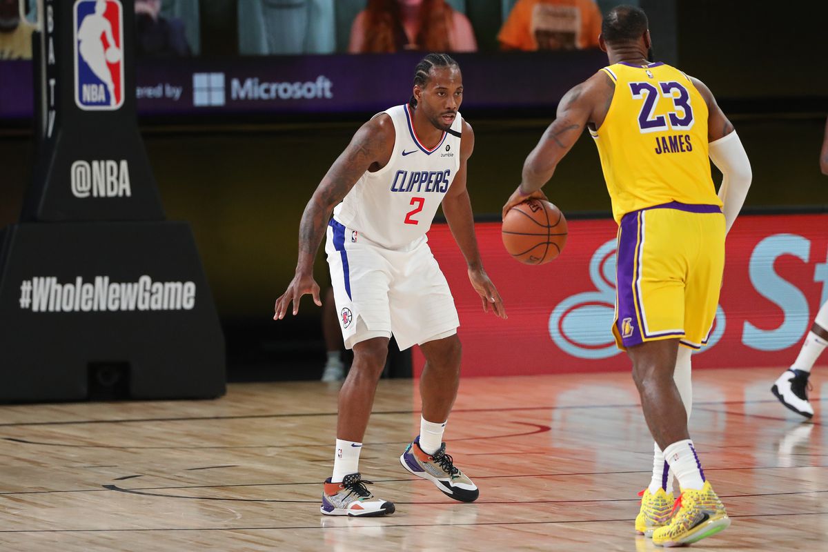 Kawhi Leonard of the LA Clippers plays defense against LeBron James of the Los Angeles Lakers during a game on July 30, 2020 at The Arena at ESPN Wide World Of Sports Complex in Orlando, Florida.&nbsp;
