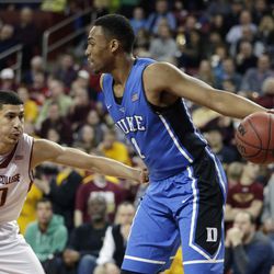 Duke forward Jabari Parker (1) holds the ball away from Boston College guard Lonnie Jackson (20) after Parker pulled in a defensive rebound during the first half of their NCAA college basketball game on the Boston College campus in Boston, Saturday, Feb. 8, 2014. (AP Photo/Stephan Savoia)