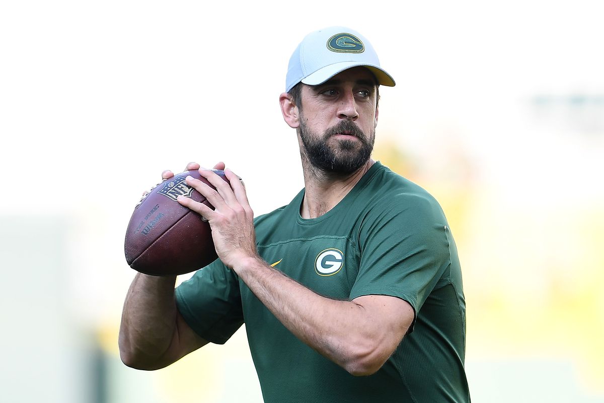 Aaron Rodgers holds a football