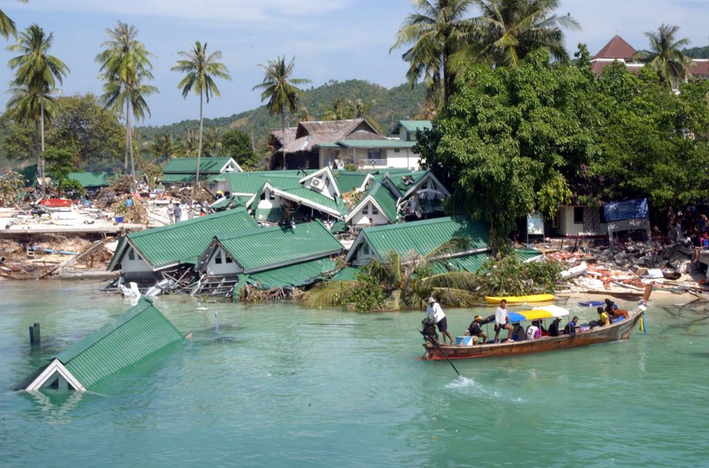 <small><strong>A boat passes by a damaged hotel, at Ton Sai Bay on Phi Phi Island, in Thailand on Dec. 26, 2004. Friday marks the 10th anniversary of one of the deadliest natural disasters in world history: a tsunami, triggered by a massive earthquake off