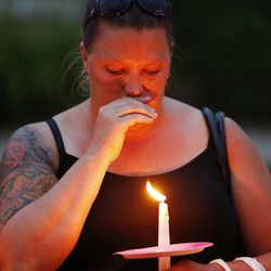 Friends gather during a candlelight vigil in Logan Thursday, July 10, 2014. Ronald Lee Haskell, a recent Logan resident, has been charged with multiple counts of capital murder in a shooting in Texas. Haskell and his family lived in Logan for several years.