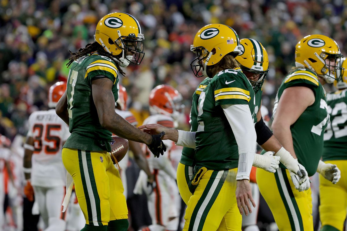 Davante Adams #17 and Aaron Rodgers #12 of the Green Bay Packers celebrate after scoring a touchdown in the second quarter against the Cleveland Browns at Lambeau Field on December 25, 2021 in Green Bay, Wisconsin.