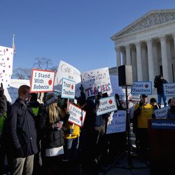People participate in a rally at the Supreme Court in Washington, Monday, Jan. 11, 2016, as the court heard arguments in the 'Friedrichs v. California Teachers Association' case. The justices were to hear arguments in a case that challenges the right of public-employee unions to collect fees from teachers, firefighters and other state and local government workers who choose not to become members.  (AP Photo/Jacquelyn Martin)