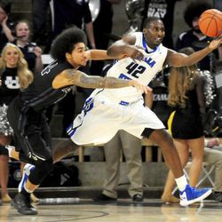 Indiana State's TJ Bell stretches for a loose ball as Utah State's Jalen Moore attempts to bat it away during an NCAA college basketball game, Saturday, Dec. 3, 2016, in Logan, Utah. (John Zsiray/Herald Journal via AP)