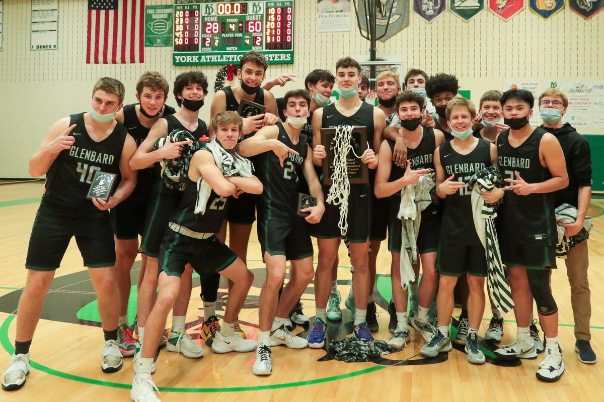 Glenbard West basketball players react after winning the 2021 Jack Tosh Holiday Classic Tournament Championship game against Lyons. 
