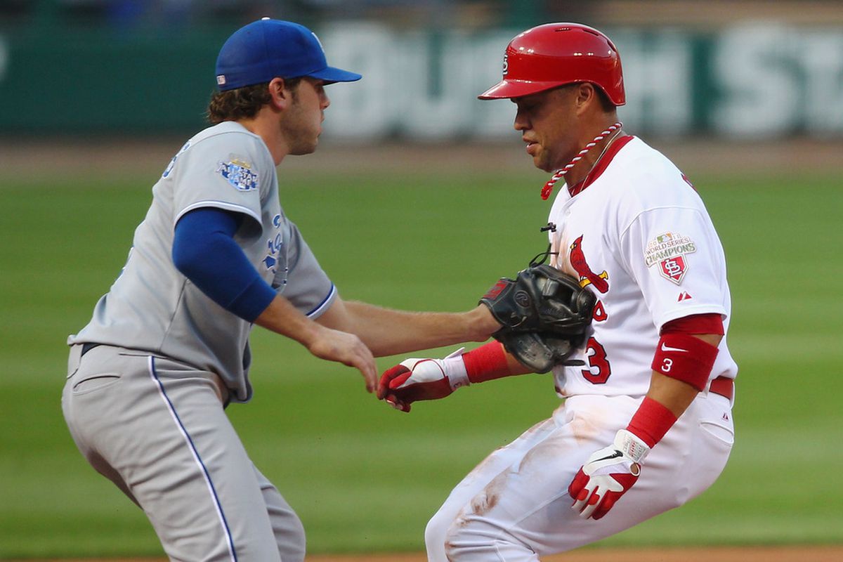 ST. LOUIS, MO - JUNE 15:  Carlos Beltran #3 of the St. Louis Cardinals is caught stealing third base by Mike Moustakas #8 of the Kansas City Royals at Busch Stadium on June 15, 2012 in St. Louis, Missouri.  (Photo by Dilip Vishwanat/Getty Images)