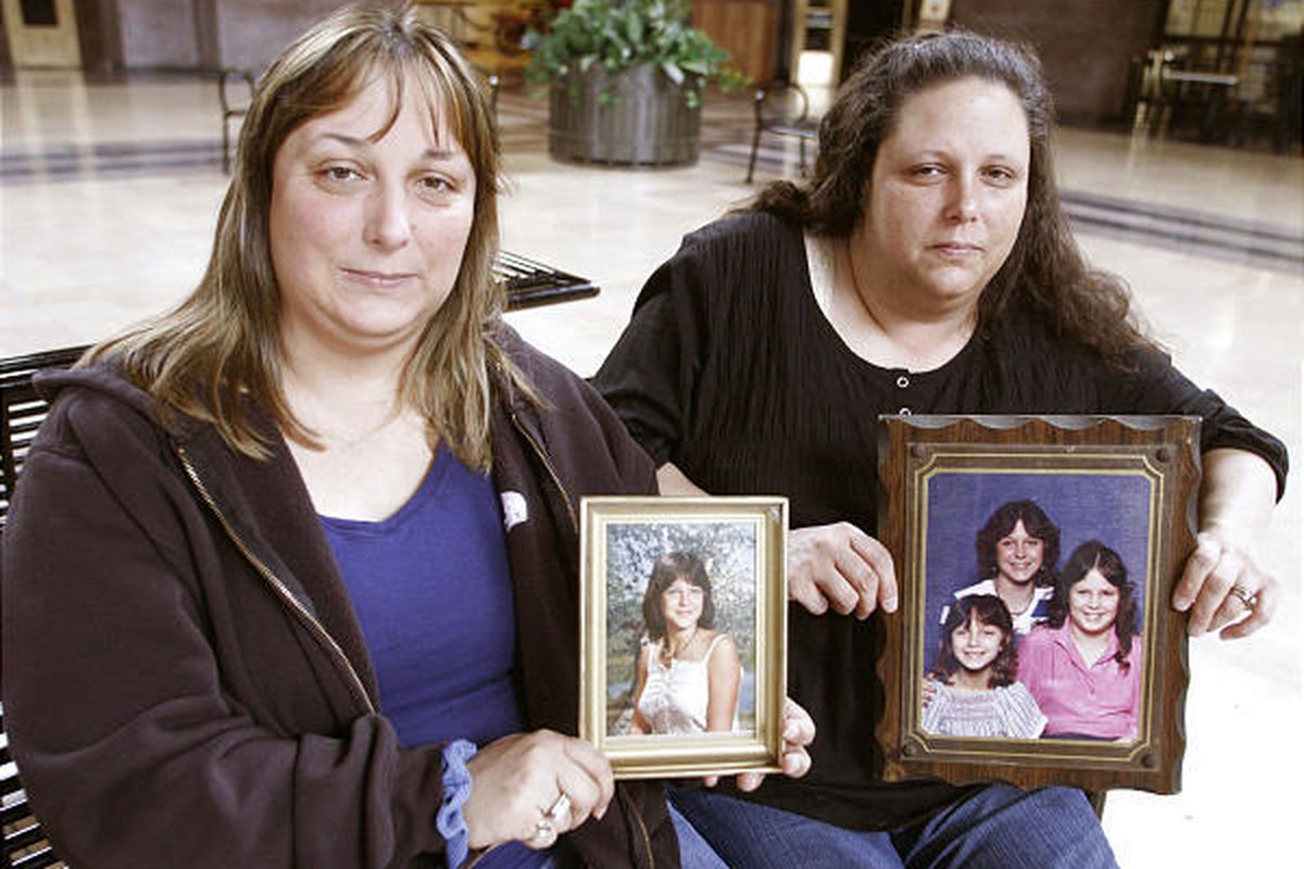Stephanie Clack, left, and Alice Beverly hold photos showing their missing sister during an interview at Union Station Feb. 4, 2010, in Kansas City, Mo.