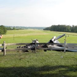 Reuben Salazar of the Texas County (Missouri) Sheriff's office takes photographs of the wreckage of the plane crash that killed Utah State Board of Education member Mark Openshaw, his wife and two of his children Friday, June 12, 2015, in western Texas County, Missouri.
