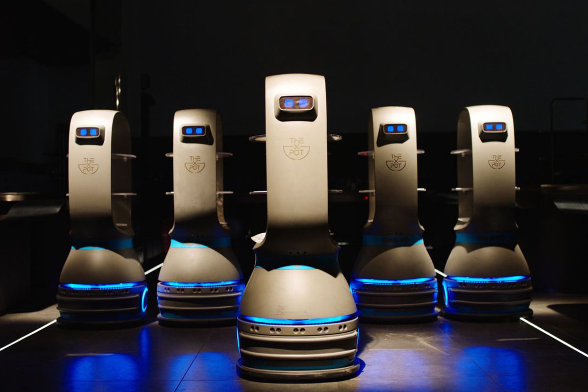 Five robots that will serve as food runners for X Pot in Chicago. They have blue eyes and are friendly.