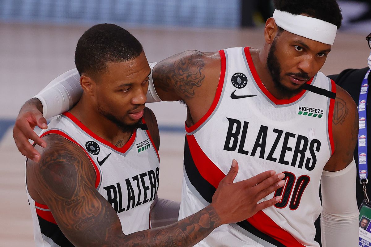 Carmelo Anthony of the Portland Trail Blazers and Damian Lillard celebrate a win against the Philadelphia 76ers following a game at Visa Athletic Center at ESPN Wide World Of Sports Complex on August 09, 2020 in Lake Buena Vista, Florida.