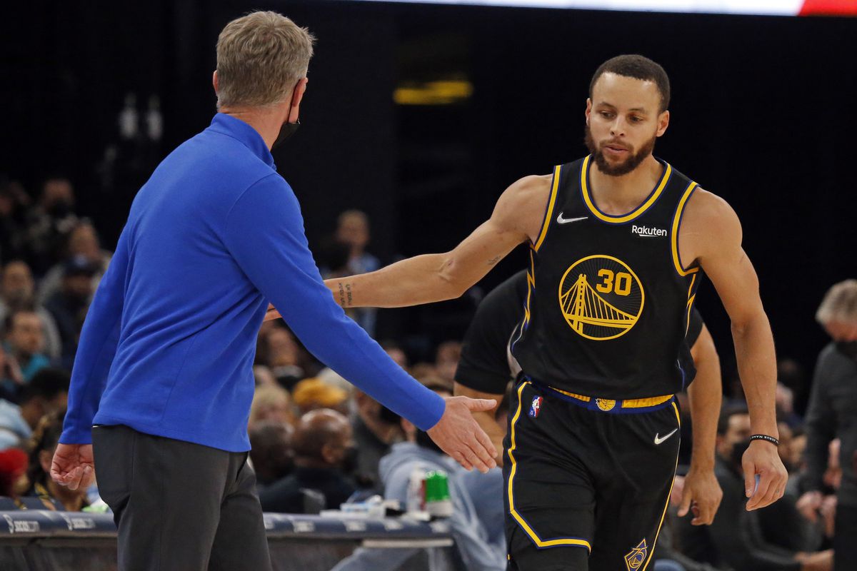 Golden State Warriors guard Stephen Curry (30) celebrates with head coach Steve Kerr (left) after a basket during the second half against the Memphis Grizzles at FedExForum.