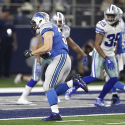 Detroit Lions' Zach Zenner (34) runs the ball in past Dallas Cowboys' Brandon Carr (39) into the end zone for at touchdown in the first half of an NFL football game, Monday, Dec. 26, 2016, in Arlington, Texas. 