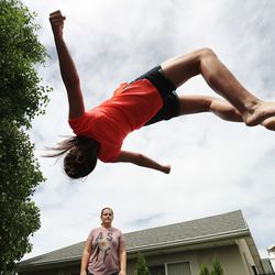 Morgan Selleneit jumps on the trampoline as her friend Macee Silvester watches at her home in Centerville on Thursday, May 31, 2018. Morgan is 15 and uses her phone around 3 hours a day, mostly on Instagram and Snapchat.
