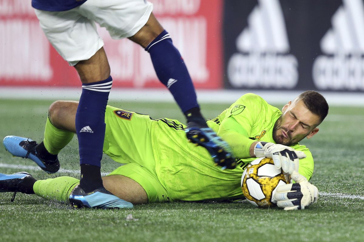 Real Salt Lake goalkeeper Andrew Putna (51) makes a save on a shot by New England Revolution forward Teal Bunbury, left, during the second half of an MLS soccer match at Gillette Stadium, Saturday, Sept. 21, 2019, in Foxborough, Mass.
